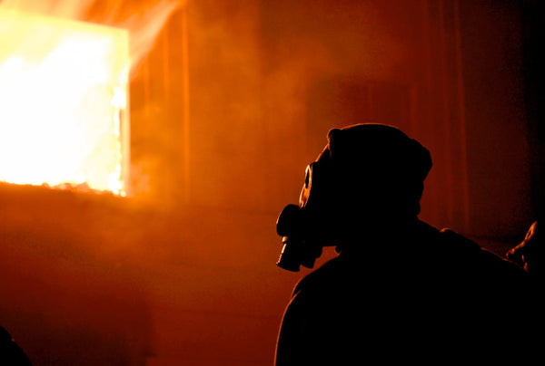 Silhouette of a man wearing a gas mask