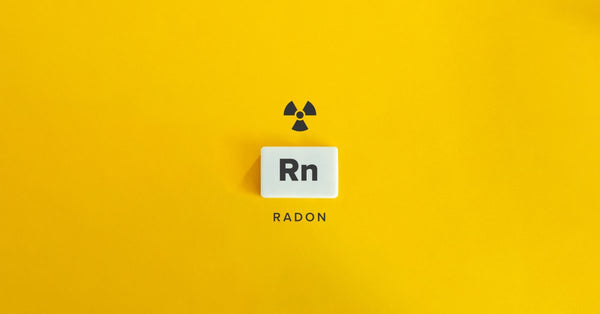 The chemical symbol Rn in a white square on a yellow background with the "radioactive" symbol above it and the word "Radon" below.