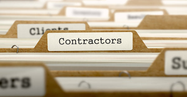 A brown file folder reads "Contractors" in a full filing cabinet drawer with more folders blurred in the background.