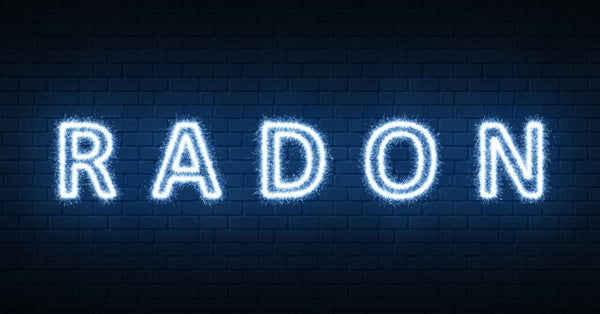 The word radon is illuminated and sits against a dark, brick background. The word is written in capital letters.