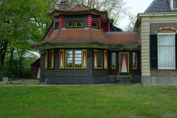 a distinctively designed house featuring colorful accents and intricate architectural details