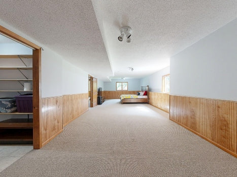 an empty garden-level apartment with a long hallway